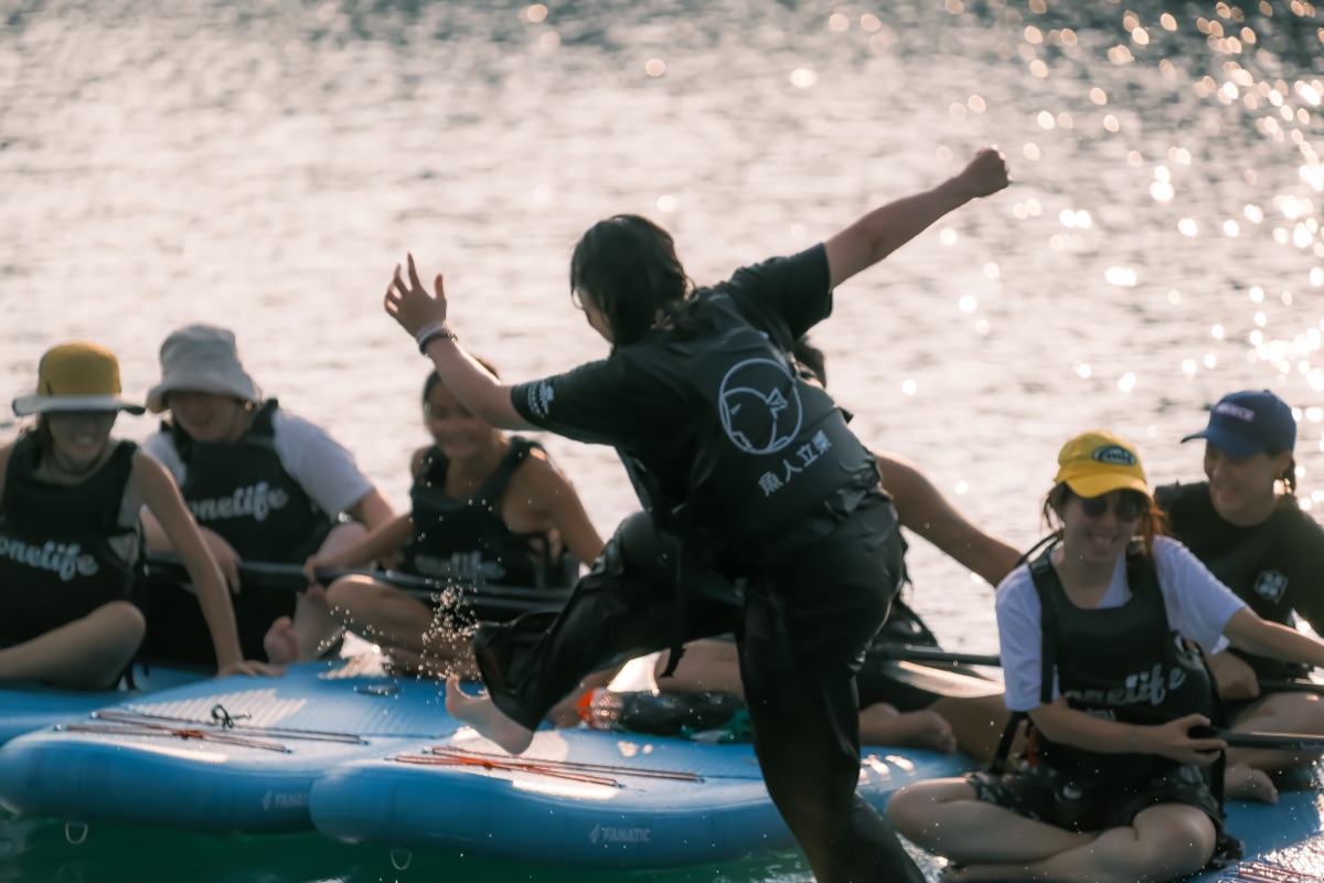 Group having fun on SUP boards at golden hour on Sun Moon Lake